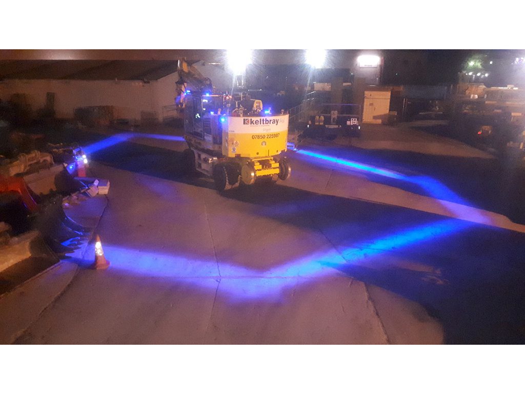 Road-rail vehicle equipped with illuminated exclusion zone